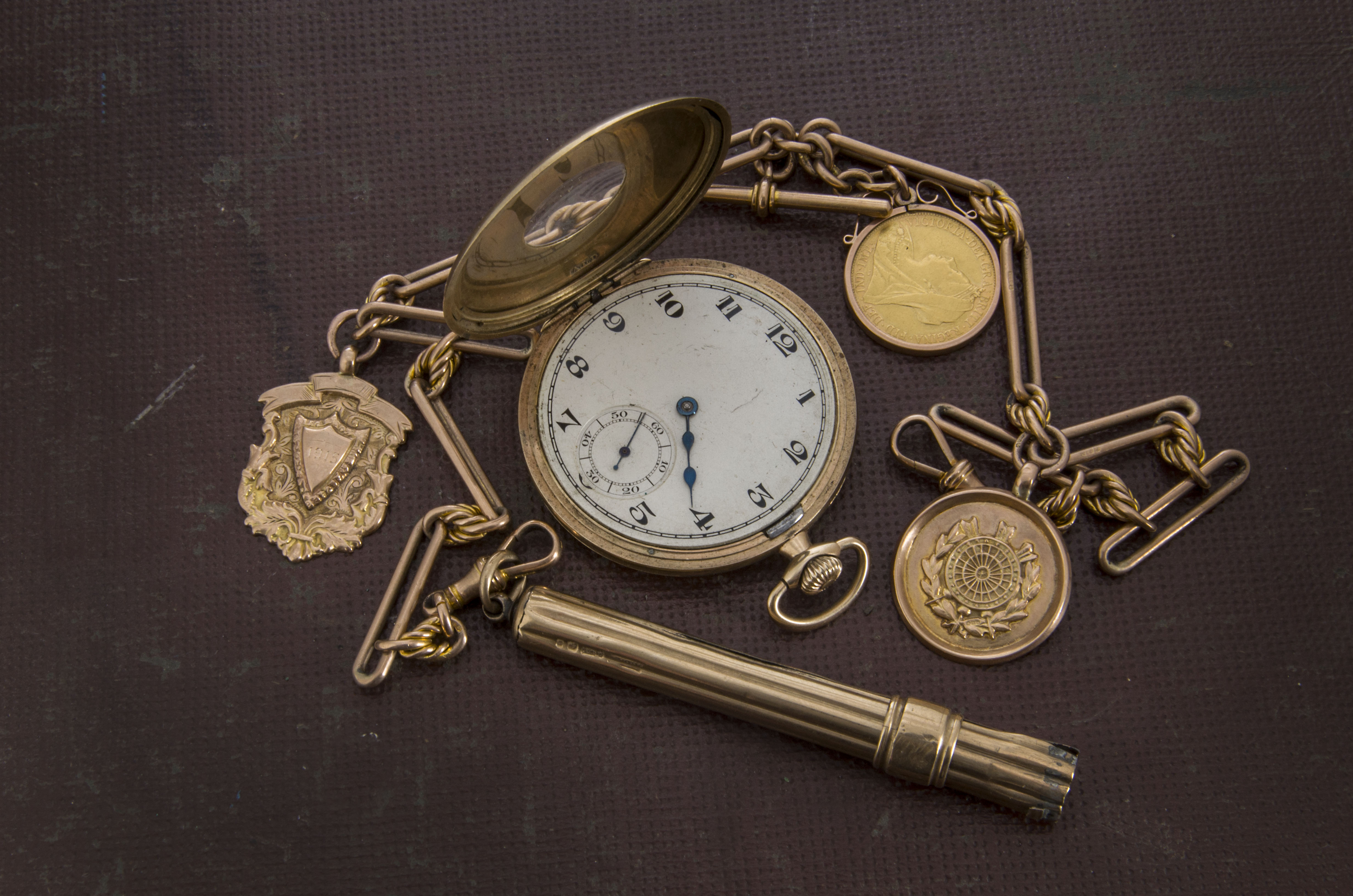 Gold pocket watch and chain with coins