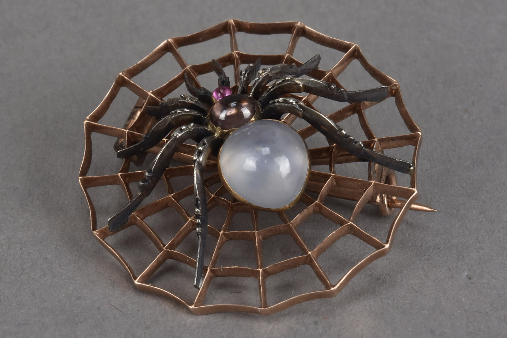 A Carlo Giuliano star sapphire and gem set spider brooch